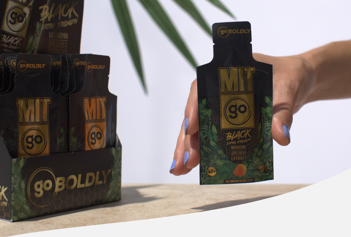 A person holding MIT45 GO next to a box of them