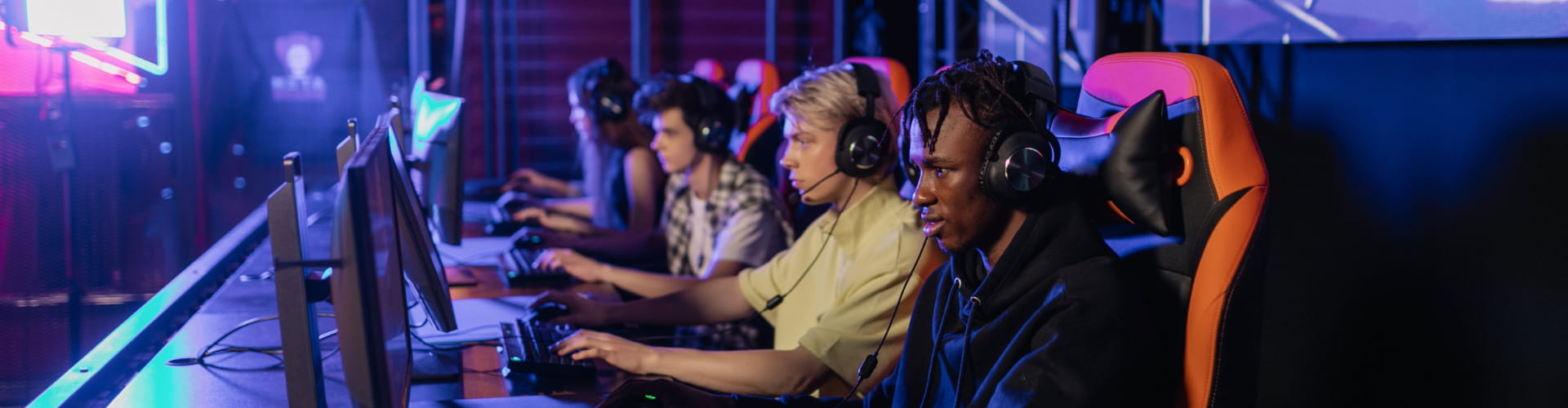 Four people in multi-player gaming setting